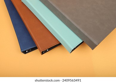 Personalized binding, leather folder cover, leather binding, binder, binder, office binding, corporate gift. Concept shot leather binding, top view, colorful