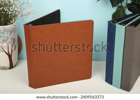 Personalized binding, leather folder cover, leather binding, binder, binder, office binding, corporate gift. Concept shot leather binding, top view, brown color