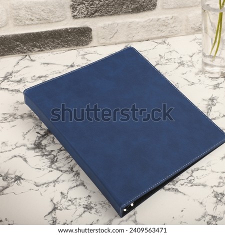Personalized binding, leather folder cover, leather binding, binder, binder, office binding, corporate gift. Concept shot leather binding, top view, blue color