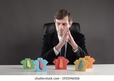 Personnel change. The boss reflects on the background of colorful origami men. Career ladder. Rational use of labor resources. HR manager. 