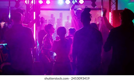 Persons at club interrupted by police lights, funky people stopping the music after seeing law enforcement officers. Group of friends running away from dance floor and nightclub. Handheld shot. - Powered by Shutterstock