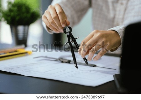 Person's engineer Hand Drawing Plan On Blue Print with architect equipment, Architects discussing at the table, team work and work flow construction concept.