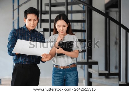Person's engineer Hand Drawing Plan On Blue Print with architect equipment, Architects discussing at the table, team work and work flow construction concept.