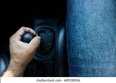 Person's Hand Changing Gear While Driving Car.hand Shifting The Gear Stick