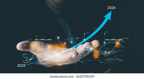 A person's hand cradles a glowing digital interface showing a financial chart with an upward arrow projecting growth from 2025 to 2026.