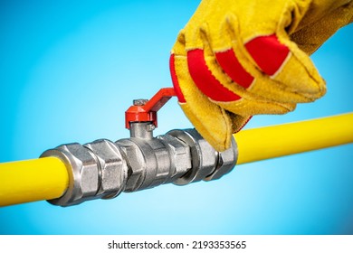 Person's Hand In Glove Opens Or Closes Red Gas Valve On Gas Pipe. Repair Gas Pipeline. Ban Of Natural Gas. 