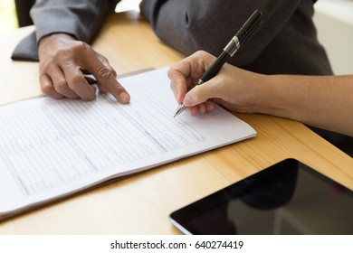 Person's Hand Hold Ballpoint Pen Writing On Blank Application Form Paper Sheet, Fill In Empty Document Template, Applying For Auto Car Insurance