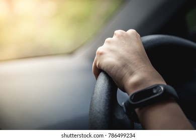 Person's Hand Holding Car Steering Wheel While Driving A Vehicle For Traveling 