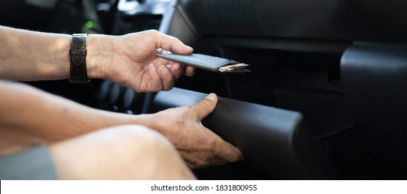 person's hand take wallet cash   credit card from the glove compartment in the car