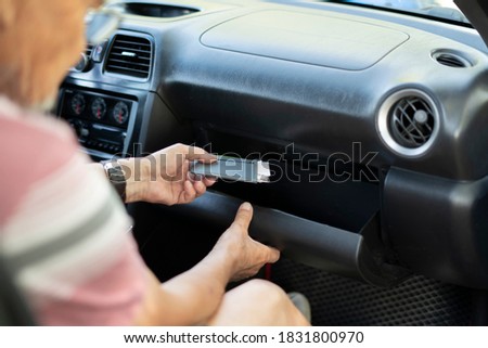 person's hand take wallet cash and credit card from the glove compartment in the car