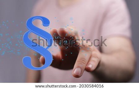 A person's hand touching 3D rendered section sign