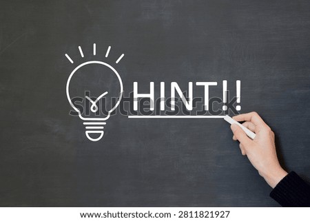 Person's hand underlining the hint letters