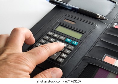 Person's Hand using a Calculator