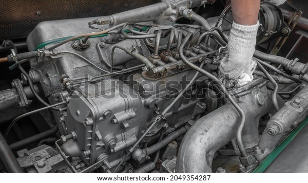 a person\'s hand wipes the engine\
from dirt with a rag. advertising picture. clean\
engine.