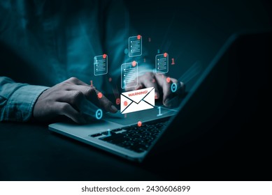 A person's hands are shown typing on a laptop, surrounded by digital email icons of documents and a warning sign. The image conveys a sense of urgency and attention to cybersecurity threats.