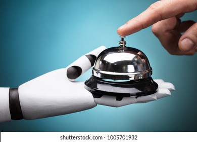 Person's Ringing Service Bell Hold By Robot On Turquoise Background