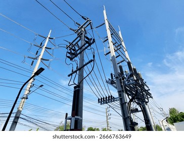 The perspective of 115kV Underground Cable Riser Pole and 22kV Underground Cable Post Pole in Substation on clouds in the blue sky background. 