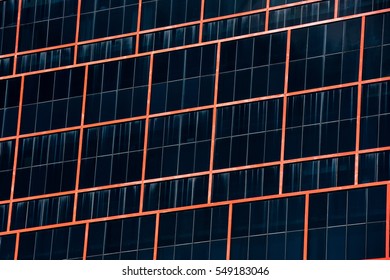 Perspective angle view to textured background of modern office glass building with red iron line skyscrapers over blue cloudy sky