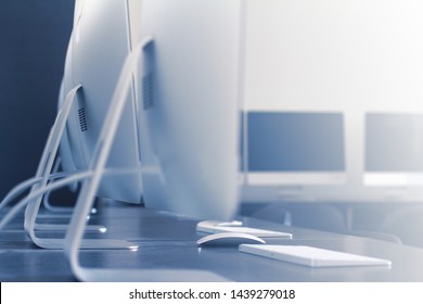 Perspective Closeup View Of Keyboards Workstation Computers And Mouse On Desk In A Digital College Training Center