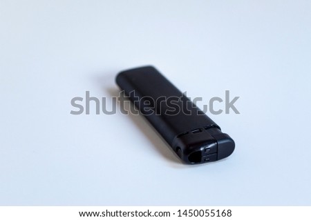 Perspective front shoot of horizontal full black lighter on white surface