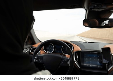 Driver’s perspective from inside a car with dashboard visible and view of the road outside.