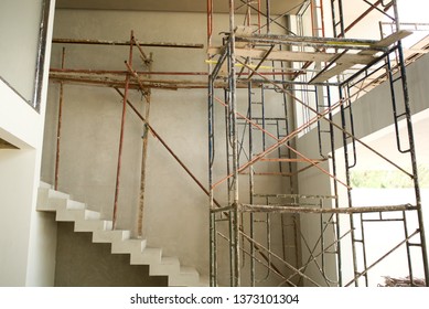 Perspective Modern Architecture Of House Under Construction With Scaffolding Inside.