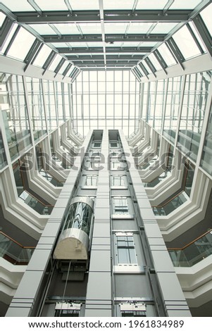 Perspective of office lobby: round-shaped roof and glassy walls in modern hall with elevator