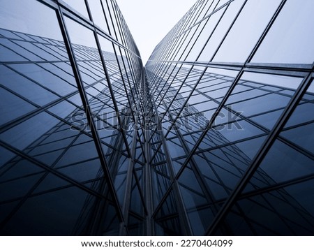 A perspective on a modern building's glass roof in a business district