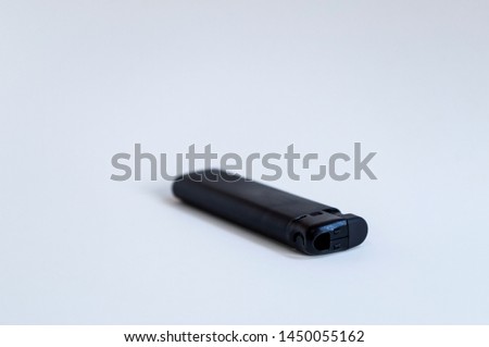 Perspective open shoot of horizontal black lighter on white surface