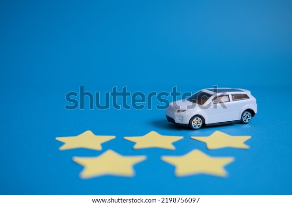 Perspective\
photo of car, five stars and blue\
background