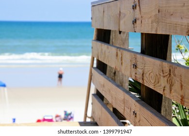 Perspective photography of wooden walkover bridge to sandy beach with blue sky, water and surf.  - Shutterstock ID 1399791947