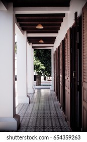 perspective semi open retro corridor tree white wall wooden door. retro patter floor - Shutterstock ID 654359263