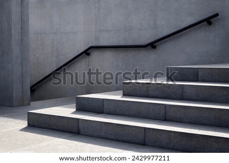Perspective of the staircase and railing on concrete or marble walls for background.

