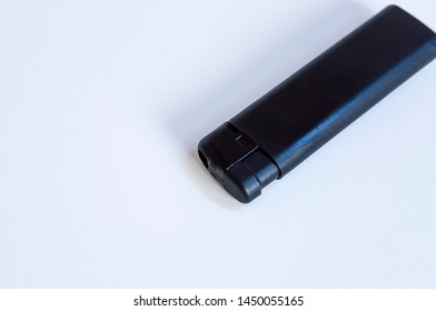 Perspective top shoot of angled full black lighter on white surface