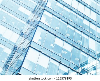 Perspective and underside angle view to textured background of modern glass building skyscrapers at night - Powered by Shutterstock