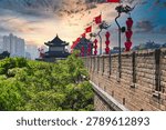 Perspective view of the ancient massive stone wall and watchtower adorned with red lanterns in Xi