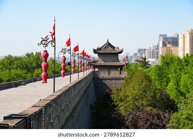 Perspective view of the ancient massive stone wall and watchtower adorned with red lanterns in Xi'an, Shaanxi, China