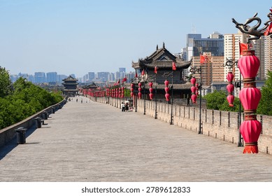 Perspective view of the ancient massive stone wall and watchtower adorned with red lanterns in Xi'an, Shaanxi, China