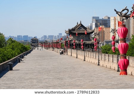 Perspective view of the ancient massive stone wall and watchtower adorned with red lanterns in Xi'an, Shaanxi, China