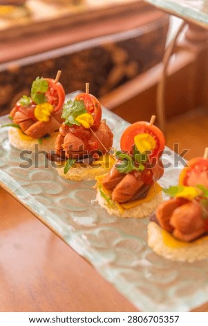 Perspective view of assorted appetizer skewers on a serving board highlighting colorful fresh ingredients.