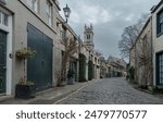 Perspective view of Circus Lane is a picturesque cobbled street in Stockbridge of Edinburgh, This residential street with pretty flower-covered terraced mews houses. Space for text, Selective focus.