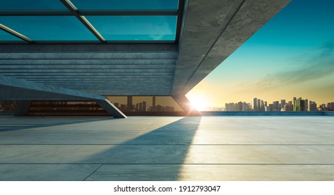 Perspective view of empty concrete floor and modern rooftop building with sunset cityscape scene. Mixed media - Shutterstock ID 1912793047