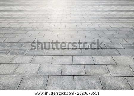 Perspective view of empty grey stone tile floor background with geometric pattern and texture suitable for product display or backdrop presentation.