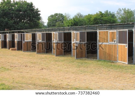 Perspective view of empty horse stables