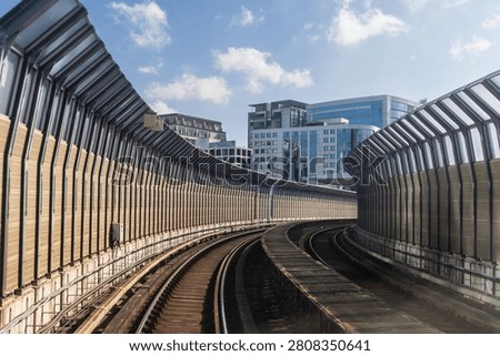 Perspective view of mass rail transit train passing through tracks with sound barrier in the city of Kuala Lumpur. Sound barrier tunnels are designed to minimize noise pollution.