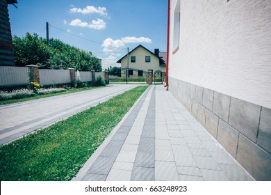 Perspective View of Monotone Gray Brick Stone on The Ground for Street Road. Sidewalk, Driveway, Pavers, Pavement in Vintage Design Flooring Square Pattern Texture Background, house, grass