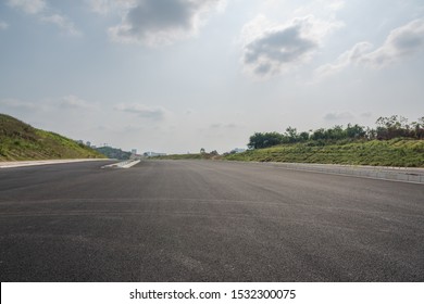 Perspective view of new asphalt road and sky in modern city suburb - Shutterstock ID 1532300075