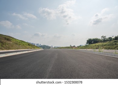 Perspective view of new asphalt road and sky in modern city suburb - Shutterstock ID 1532300078