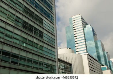 Perspective view of office building with cloudy sky background.