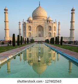 A perspective view on Taj Mahal mausoleum with reflection in water. Agra, India.